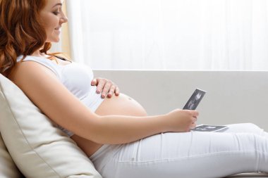 pregnant woman with ultrasound scans clipart
