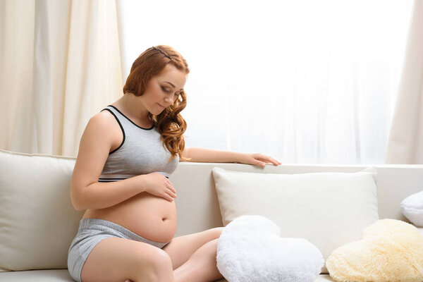 pregnant woman touching her belly
