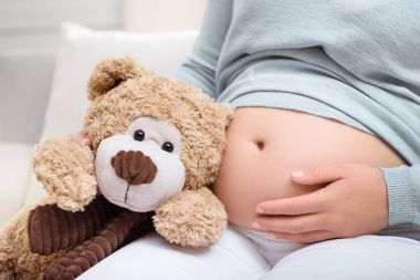 pregnant woman with teddy bear 