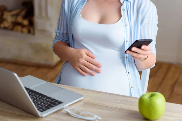 Mulher grávida usando smartphone — Fotografia de Stock