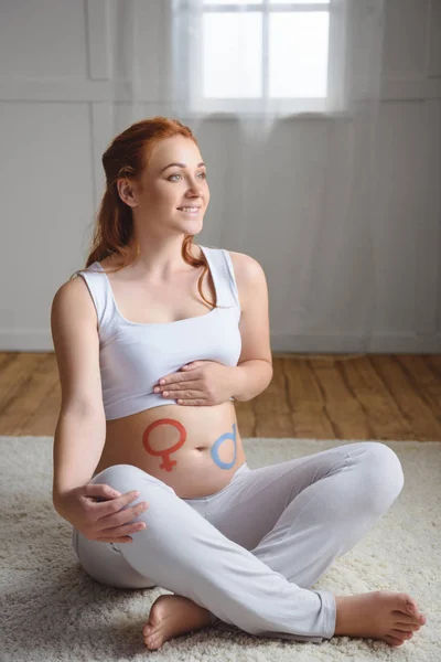男の子か女の子のシンボルと妊娠中の女性 — ストック写真