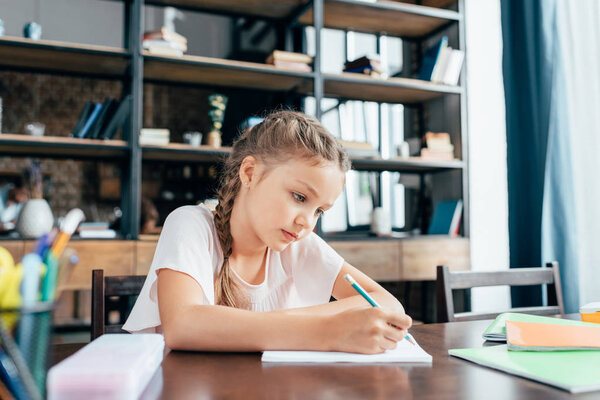 little girl writing homework