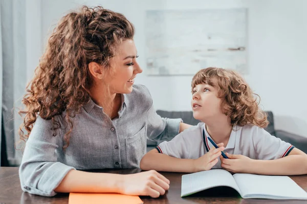 Mother and son doing homework — Stock Photo, Image