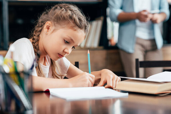 little girl writing homework