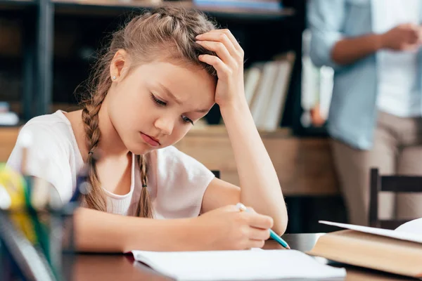 Little girl writing homework — Stock Photo, Image