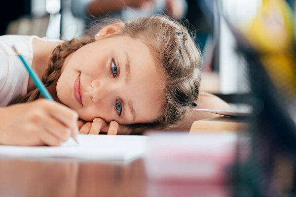 little girl writing homework