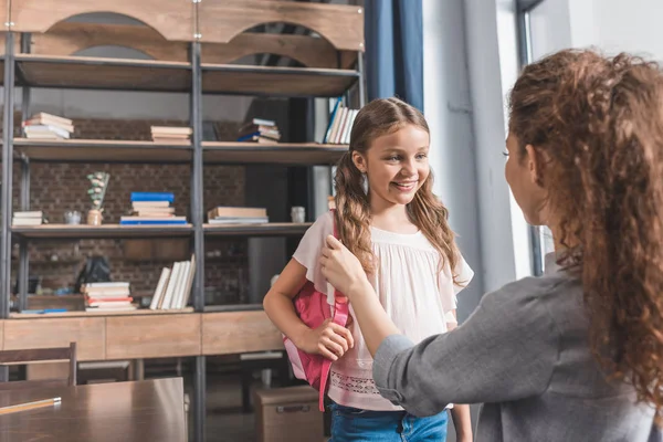 Mother preparing daughter for school — Stock Photo, Image