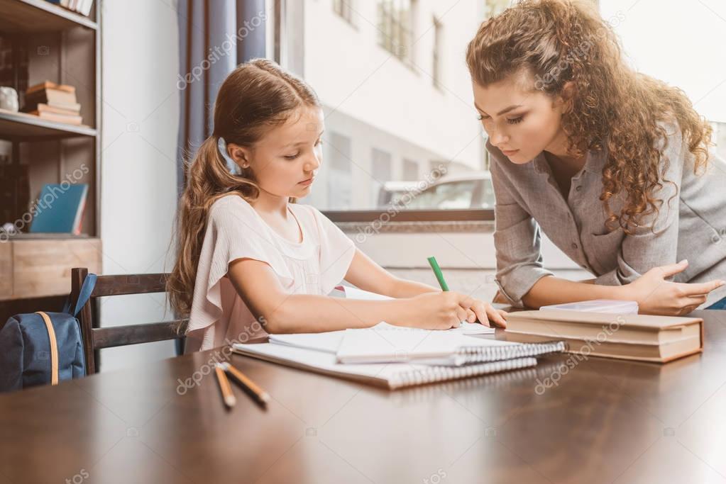 mother and daughter doing homework together