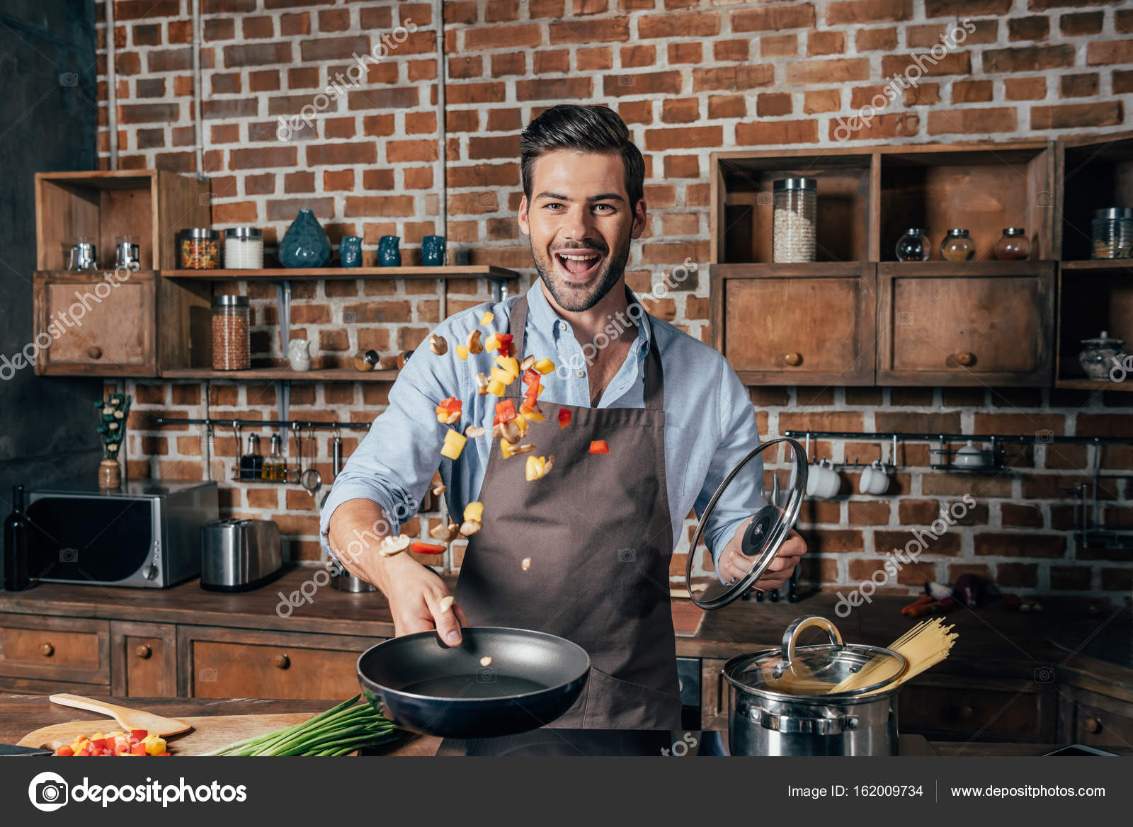 Young man cooking — Stock Photo © AlexLipa 162009734