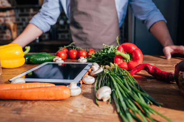 man cooking with tablet