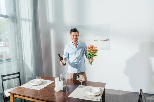 Man with bouquet of flowers and wine — Stock Photo, Image