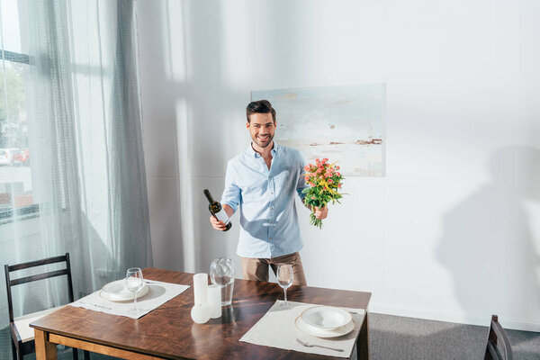 man with bouquet of flowers and wine