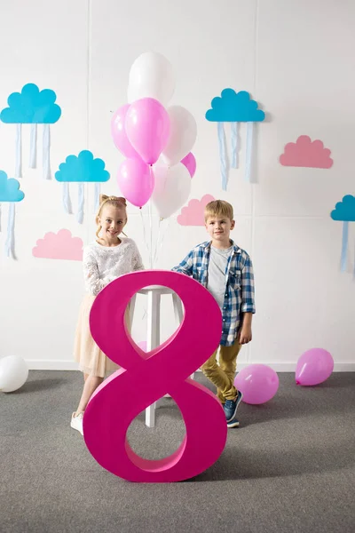 Boy and girl with number eight — Stock Photo, Image