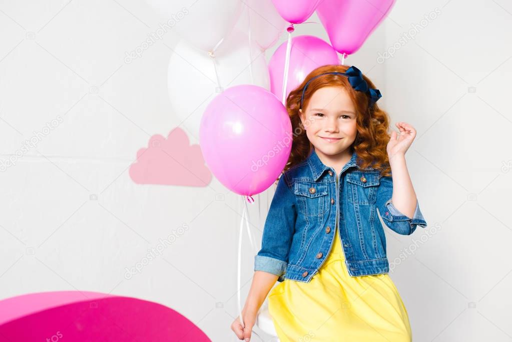 girl with balloons at birthday party