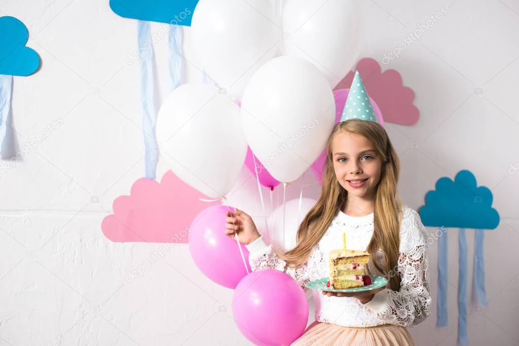 girl with birthday cake and balloons