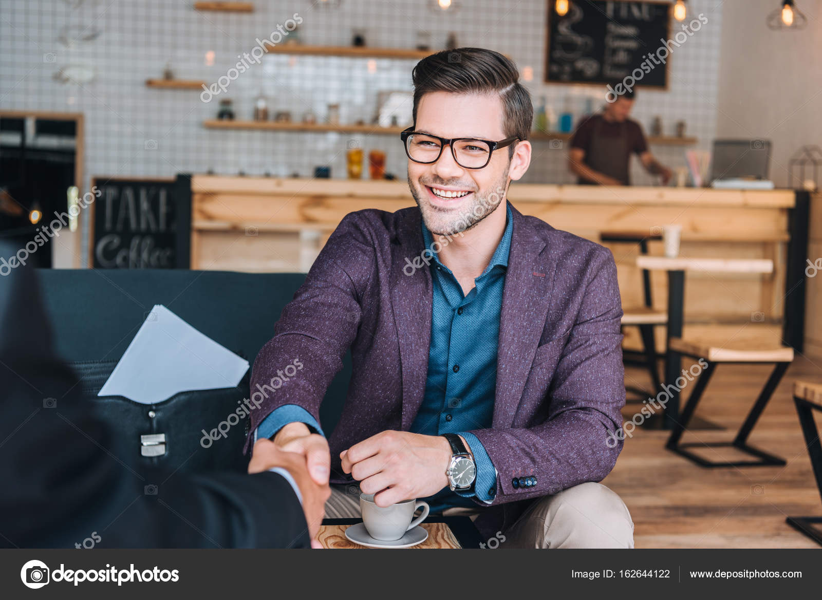 Businessmen shaking hands in cafe — Stock Photo © AlexLipa #162644122