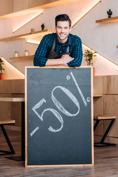 Waiter and chalkboard with 50% sale offer — Stock Photo, Image