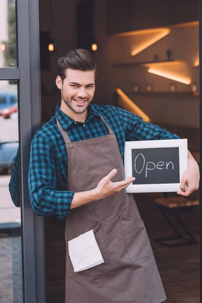 Barista pointing at chalkboard with open word — Stock Photo, Image