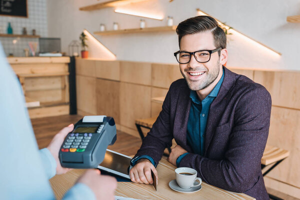 smiling businessman in cafe