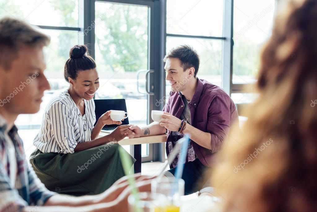 multiethnic couple drinking coffee