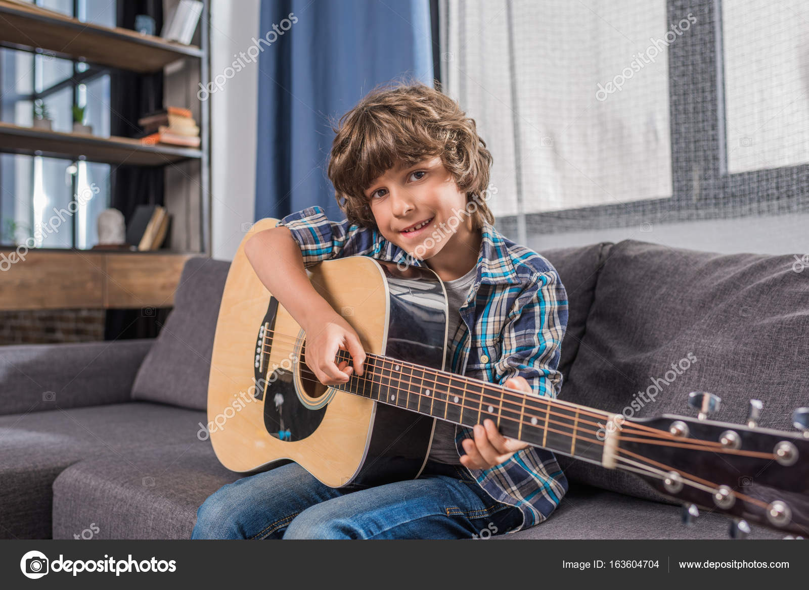Child playing acoustic guitar — Stock Photo © AlexLipa 163604704