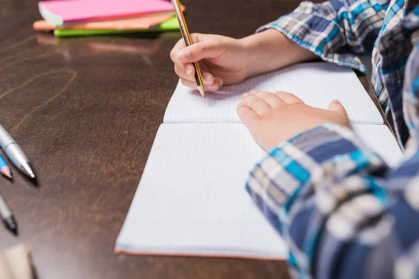 Kid writing in notebook — Stock Photo, Image