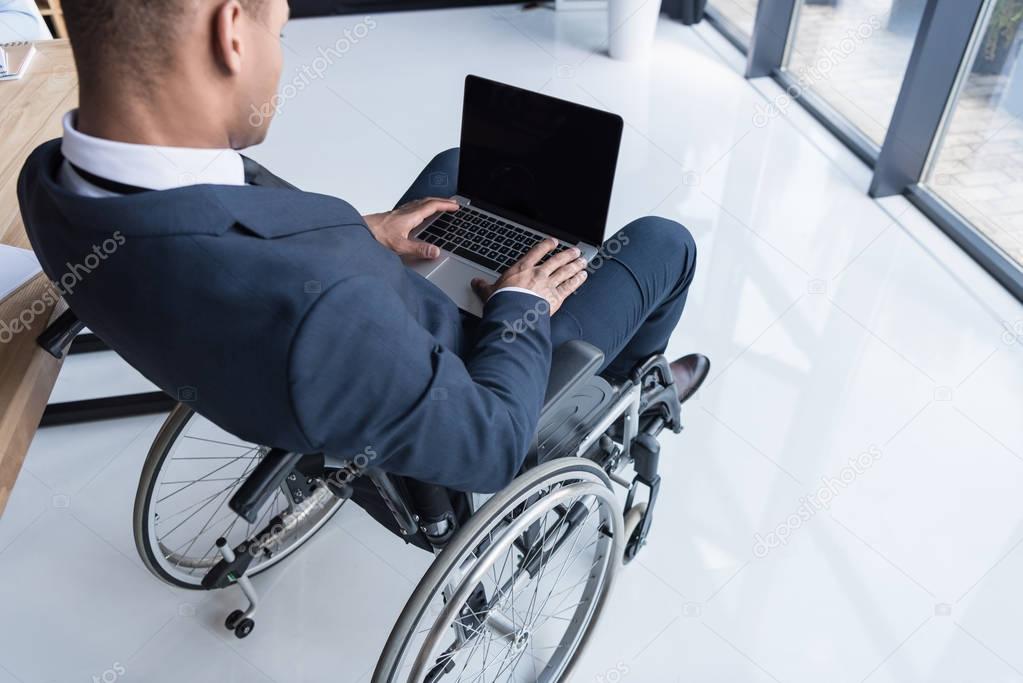 disabled african american businessman with laptop
