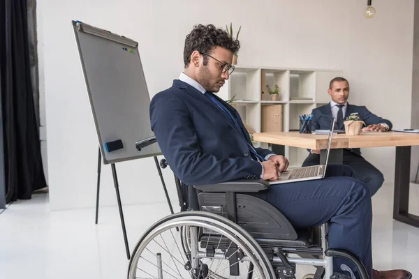 Empresário afro-americano deficiente com laptop — Fotografia de Stock