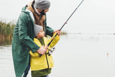 father and son fishing together clipart