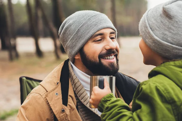 Father and son with cup of hot drink — Stock Photo, Image