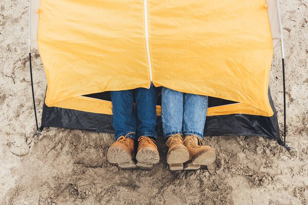 couple laying in camping tent