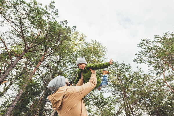 father throwing up his sun