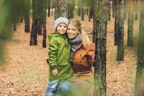 Mother and son in autumn forest — Stock Photo, Image