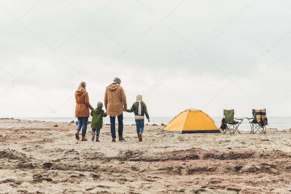 family walking to camping tent