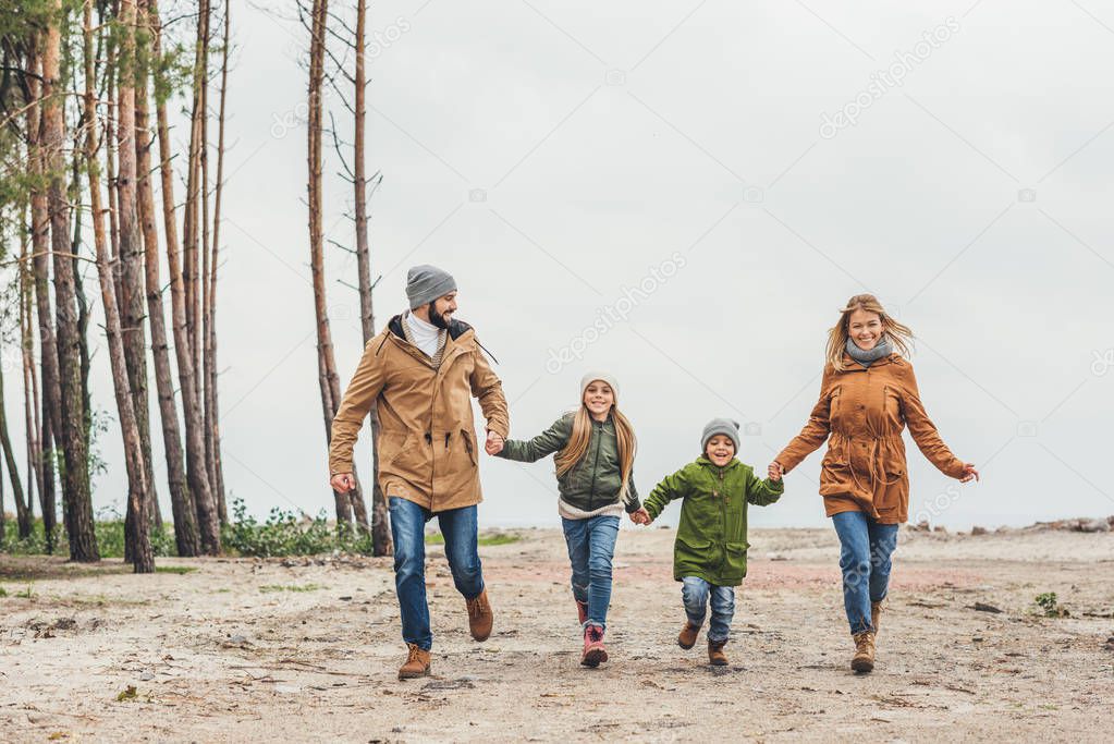 family running and holding hands
