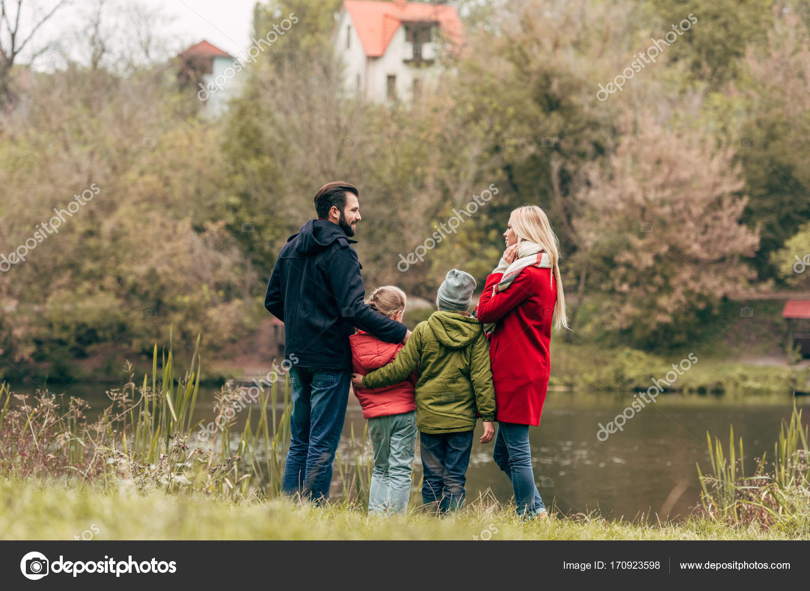 Young family near lake — Stock Photo © AlexLipa #170923598