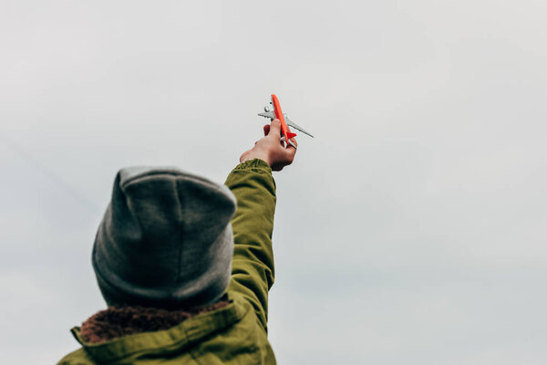 boy holding toy plane