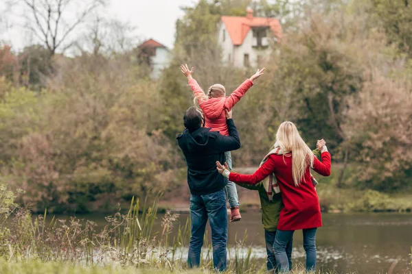 Ung familj nära lake — Stockfoto