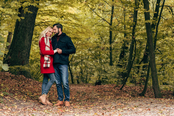 happy couple in autumn park   
