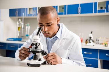 Male scientist at laboratory clipart
