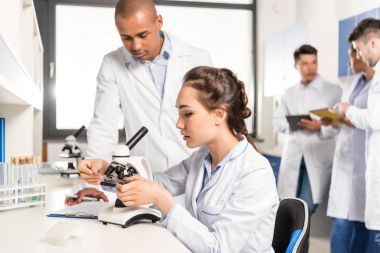 Chemists working with microscope clipart