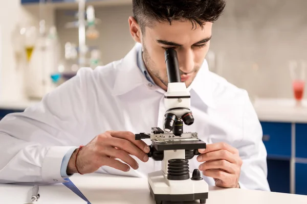 Chemist working with microscope — Stock Photo, Image