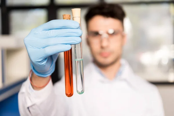 Scientist holding test tubes — Stock Photo, Image