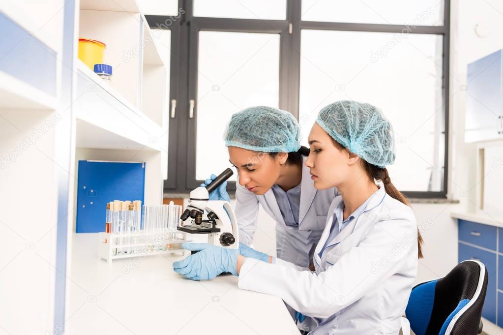 scientists working with microscope