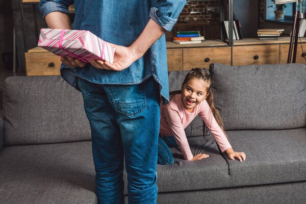 father presenting gift for daughter