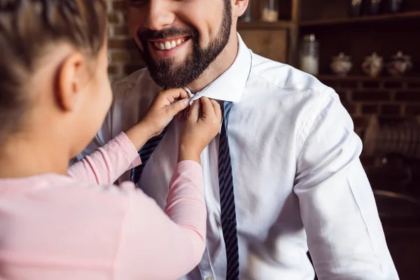 Daughter buttoning shirt for father — Stock Photo, Image