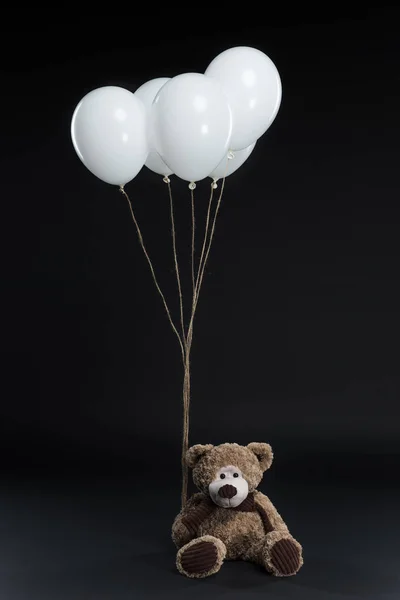 Teddy bear with helium balloons — Stock Photo, Image