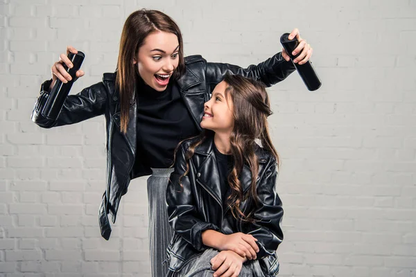 Mother holding hair sprays — Stock Photo, Image