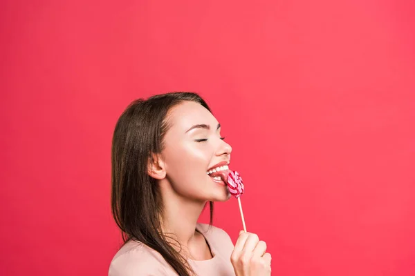 Woman licking colored lollipop — Stock Photo, Image