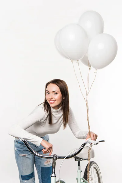 Woman leaning on bike with balloons — Stock Photo, Image